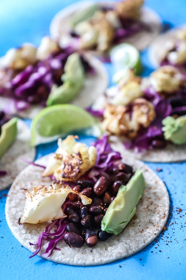 Chili lime Cauliflower Tacos made with roasted cauliflower, chili powder, fresh lime, black beans and avocado. A vegan take on Taco Tuesday!